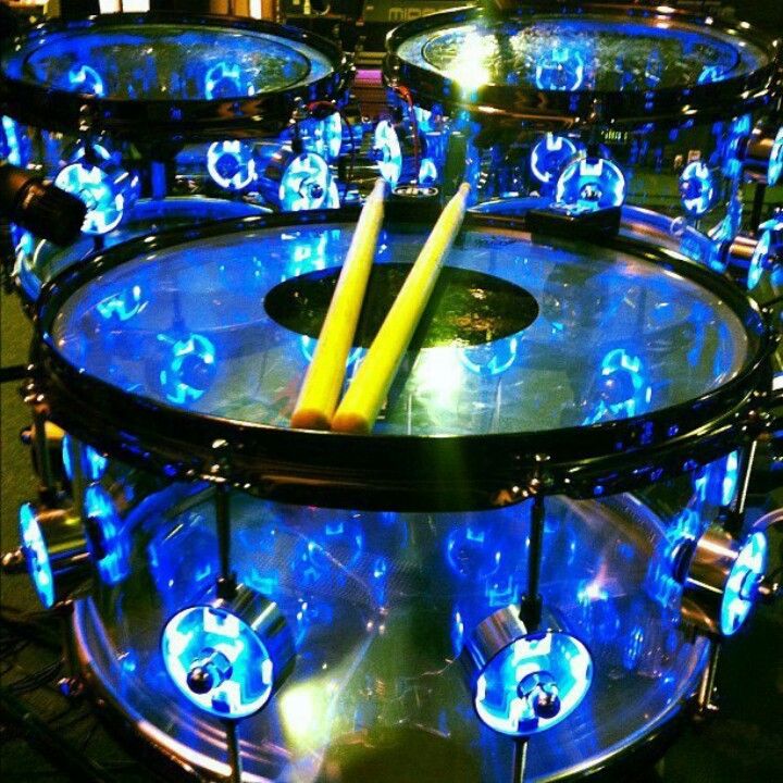 a drum with blue lights on it and a yellow stick sticking out of the top