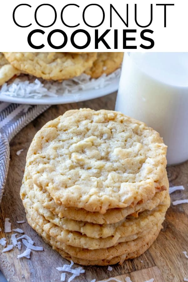 coconut cookies stacked on top of each other next to a glass of milk