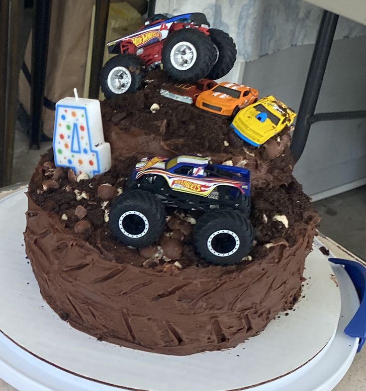 a birthday cake with monster trucks on top