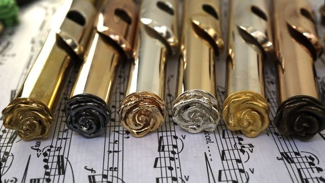 some gold and silver keys are lined up on sheet music