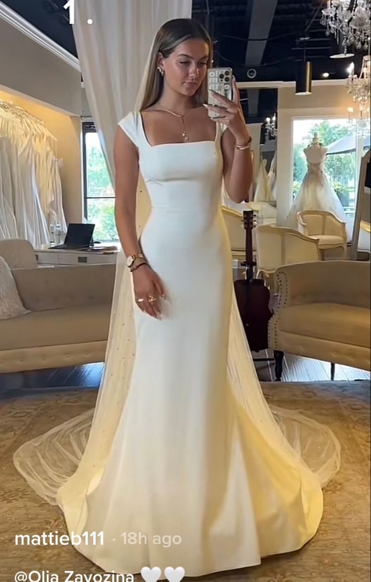 a woman is taking a selfie in her wedding dress