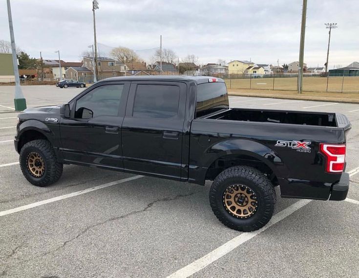 a black truck parked in a parking lot