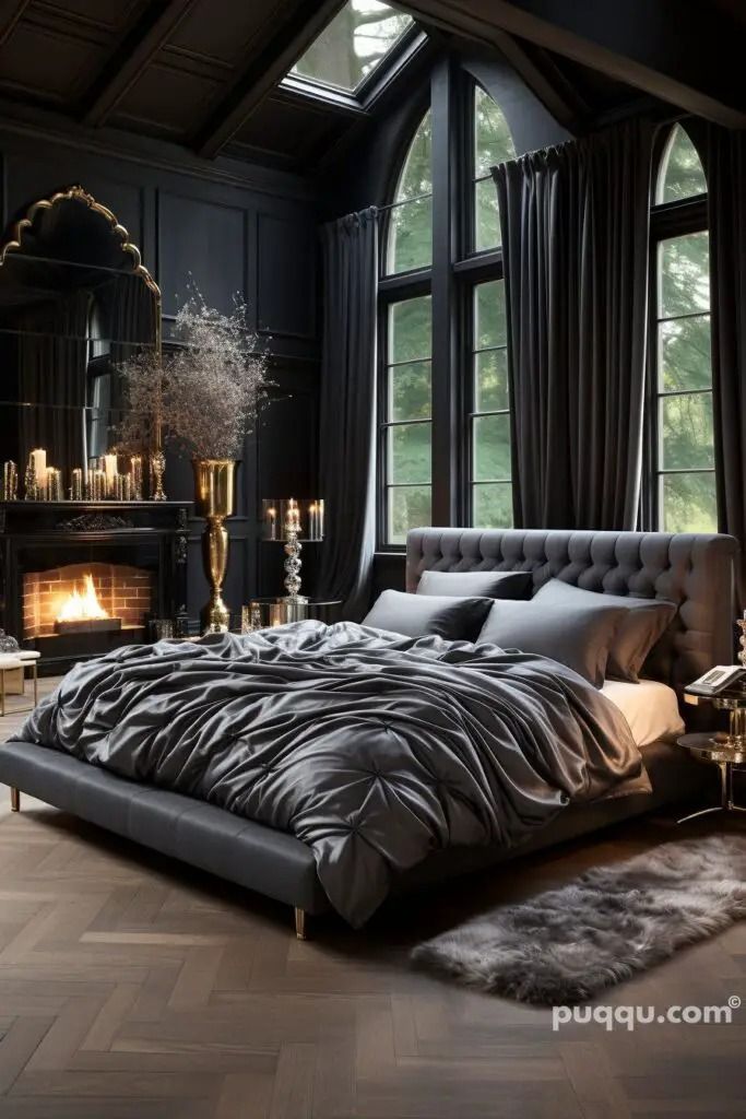 a large bed sitting next to a fireplace in a room with black walls and wooden floors