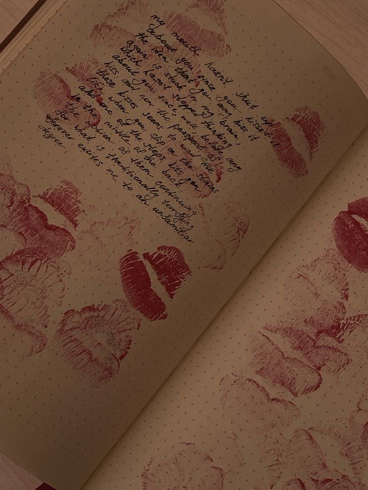 an open book with red ink on it