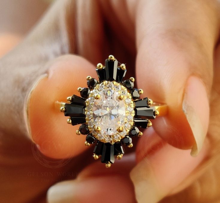 💍 𝐈𝐭𝐞𝐦 𝐃𝐞𝐬𝐜𝐫𝐢𝐩𝐭𝐢𝐨𝐧 💍 14k Gold Starburst Halo Engagement Ring / Art Deco Wedding Ring / Black Baguette / Oval Moissanite Ring / Women Sunburst Ring / Gift For Her 💍 𝐌𝐄𝐓𝐀𝐋 💍 ✶ Solid 925 Sterling Silver, 10K, 14K, White, Yellow, Rose Gold 💍 𝐎𝐕𝐀𝐋 𝐒𝐓𝐎𝐍𝐄 💍 ✶ Stone Shape : Oval cut  ✶ Stone Type : Cubic Zirconia ( CZ ) Or Moissanite (Select From Drop Down Menu) ✶ Stone Size : 7 x 5  mm ✶ Carat Weight : 0.70 Ct ✶  CZ Color : D / White ✶  CZ Clarity : VVS1 ✶  Moissanite Color : Near White (H /I) ✶  Moissanite Clarity : VVS1 💍 𝐑𝐎𝐔𝐍𝐃 𝐒𝐓𝐎𝐍𝐄 💍 ✶ Stone Shape : Round Cut ✶ Stone Type : Cubic Zirconia ( CZ ) Or Moissanite (Select From Drop Down Menu) ✶ Stone Clarity : VVS1 ✶ Stone Color : D / White ✶  Moissanite Color : Near White (H /I) ✶  Moissanite Clarity Diamond And Black Diamond Ring, Starburst Halo Ring, Onyx And Diamond Engagement Ring, Black Gold Wedding Rings, Wedding Ring Black, Sunburst Ring, Deco Wedding Ring, Art Deco Wedding Ring, Oval Moissanite Ring