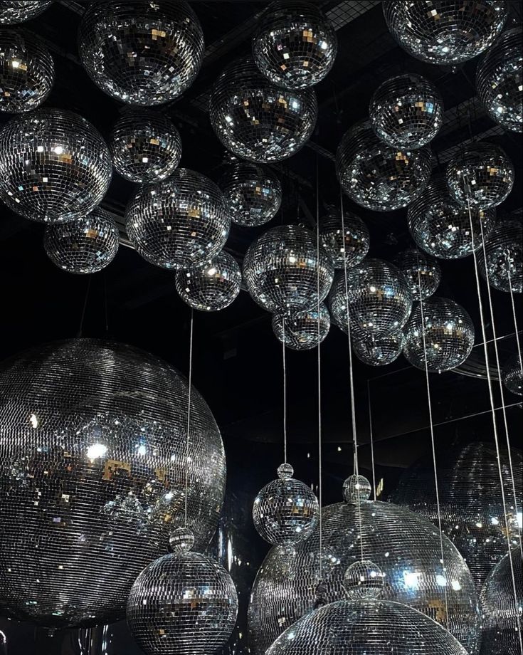 many shiny disco balls hanging from the ceiling