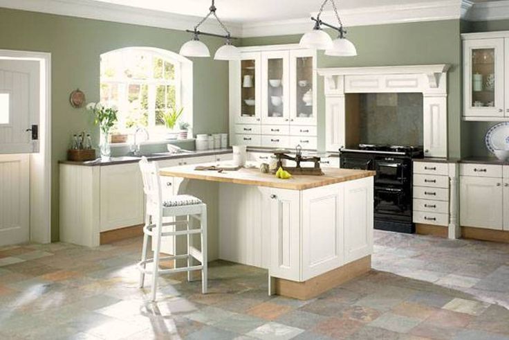 a large kitchen with white cabinets and an island