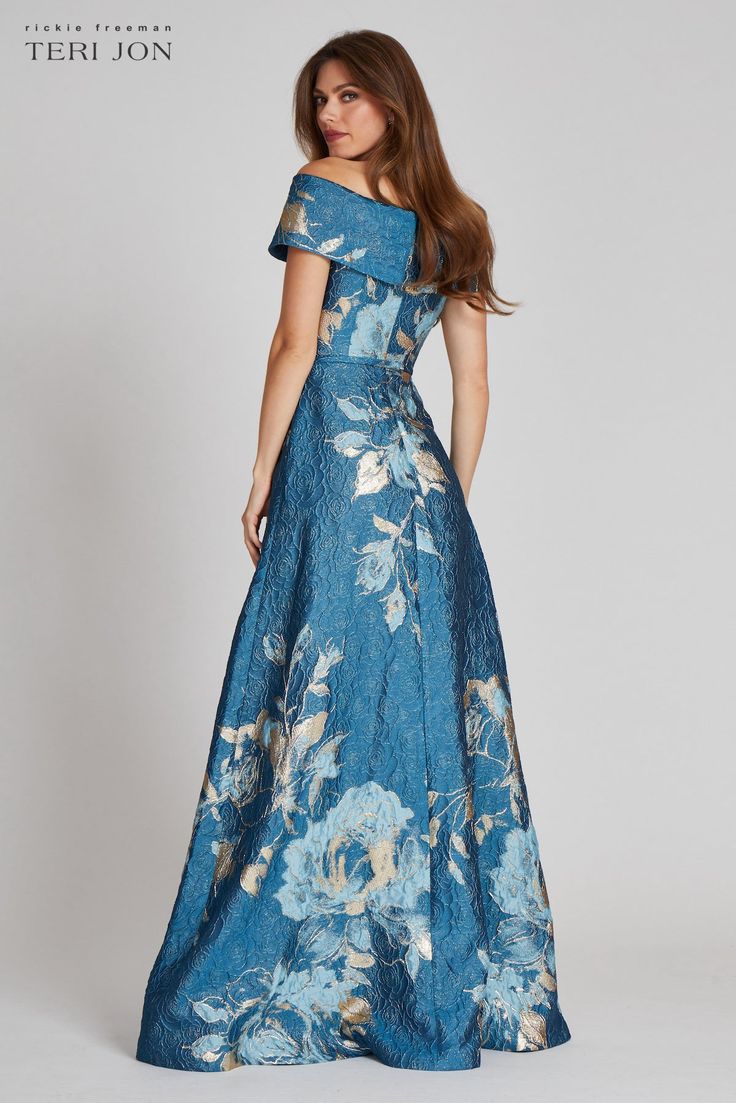 Look like a goddess in this floral patterned off the shoulder gown! Featuring a cinched waist and flared bottom, this is the perfect figure flaunting dress for your next special occasion! The sleeve is very adjustable and can be worn multiple ways. A snap closure belt is also included. This silhouette looks flattering on all body types and the construction of the fabric creates a smooth illusion! Perfect for the Mother of the Bride or Groom, pair with gold, nude or black heels to compliment the Bridgerton Wedding, Proper Attire, Bride Ideas, Evening Gowns With Sleeves, Mother Of The Bride Dresses Long, European Dress, Printed Gowns, Mob Dresses, Perfect Figure