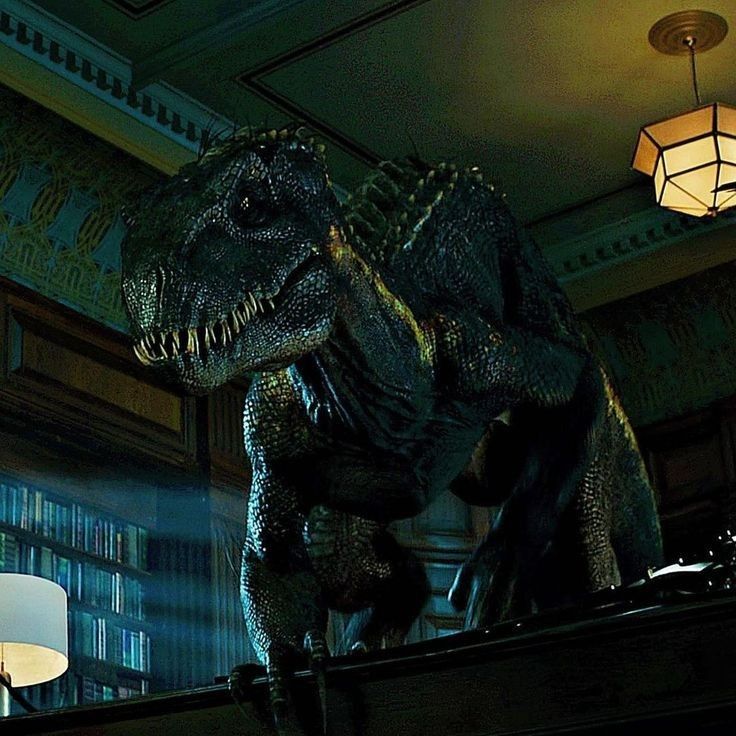 a large dinosaur standing on top of a table next to a lamp and bookshelf