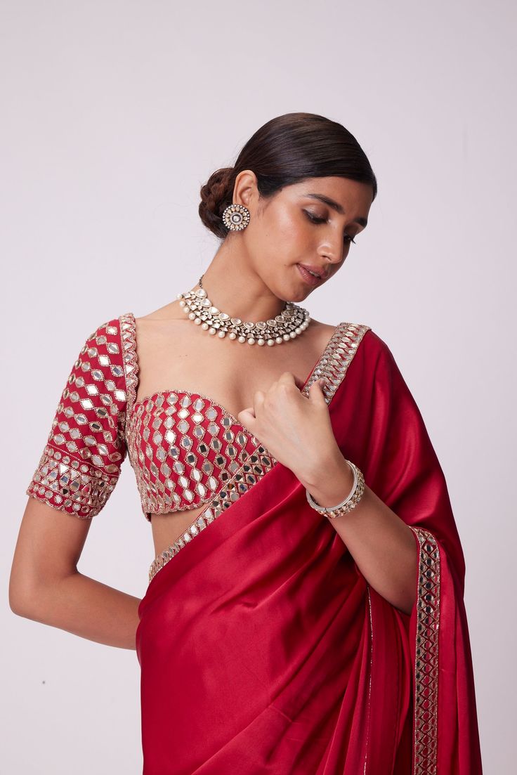 Crimson Red Satin Saree Clubbed with Real Hand Cut Mirror Embroidered Elbow Sleeve Length Blouse.From Vvani Vats Jugmug's collection.DELIVERY TIMEPlease allow 8-12 weeks for your outfit to arrive.FABRIC DETAILSSaree - SatinBlouse - GeorgetteProfessional cleaning only. Red Satin Saree, Satin Sari, Mirror Work Saree Blouse, Mirror Work Border, Red Blouse Design, Modern Blouse Designs, Red Saree Blouse, Mirror Blouse, Mirror Work Saree