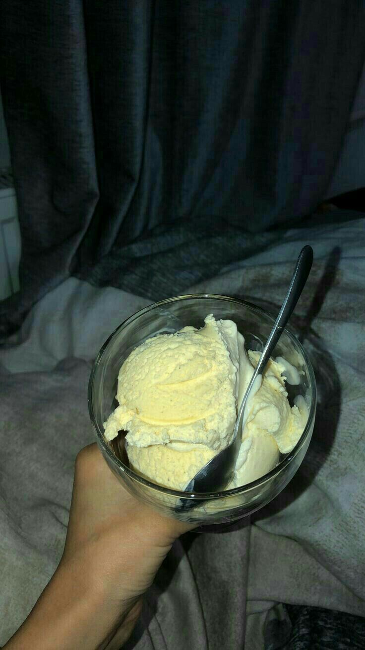 a person holding a bowl with ice cream in it