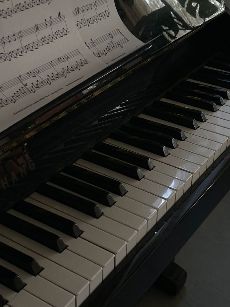 an old piano with sheet music on it