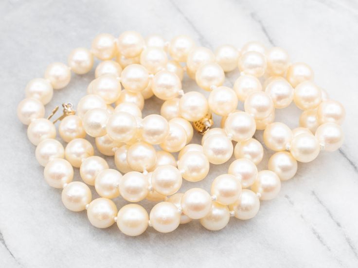 Indulge in the classic beauty of this saltwater pearl strand necklace. Each pearl has a lustrous shine and classic round shape. The strand is secured with a delicate yellow gold filigree clasp, adding a touch of warmth to this timeless piece. Elevate any outfit with this elegant necklace.Metal: 14K Yellow GoldGem: Saltwater PearlsGem Measurements: 8.4 mm, RoundLength: 33 InchesMarks: "14K G" Stamped on the clasp Classic Cream Pearl Chain Necklace, Classic Gold Pearl Necklace, Classic Cream Pearl Necklace With Pearl Charm, Classic Single Strand Pearl Necklace With Round Beads, Cream Single Strand Pearl Necklace, Classic Yellow Gold Pearl Necklace, Formal Single Strand Cream Pearl Necklace, Formal Cream Single Strand Pearl Necklace, Classic Pearl Necklace For Anniversary