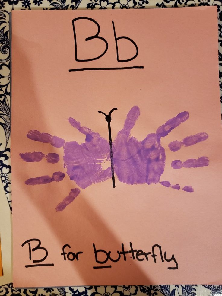 a child's handprint on a piece of paper with the letter b for butterfly