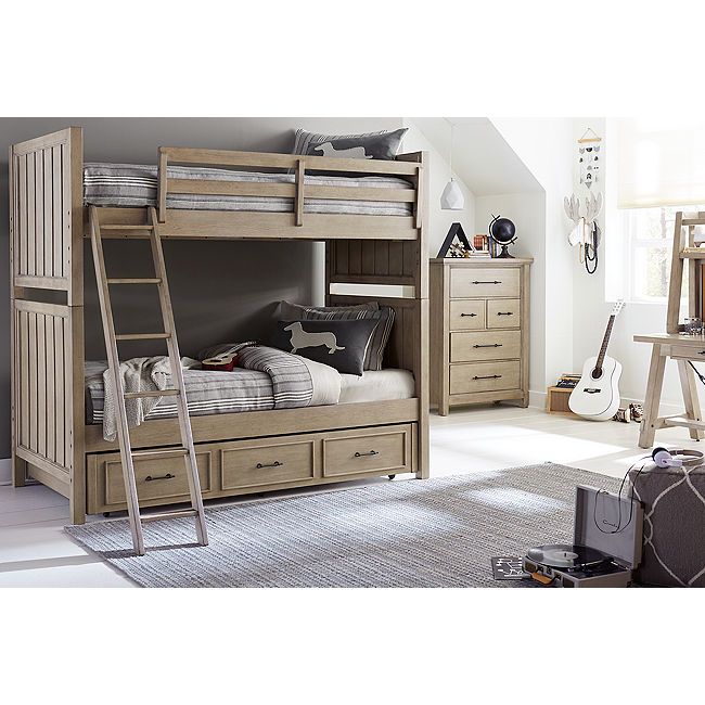 a bedroom with bunk beds and drawers in it