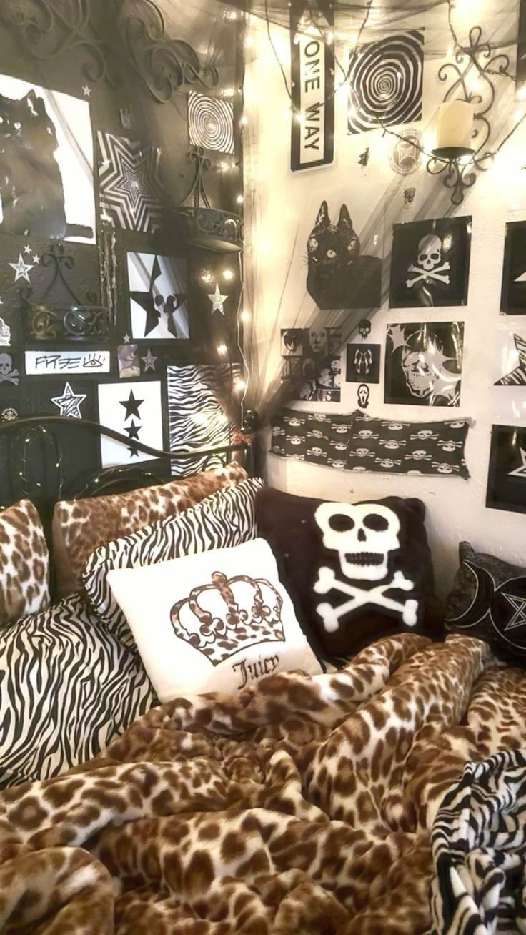 a bedroom with zebra print bedding, pillows and pictures on the wall above it