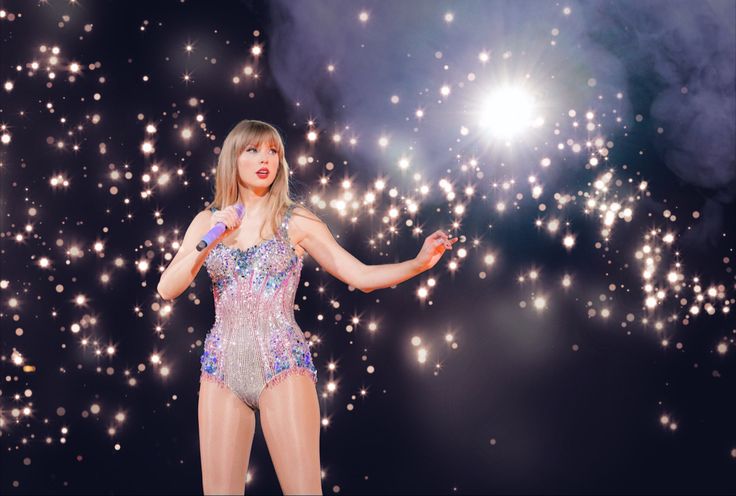 taylor swift performing on stage with fireworks in the background