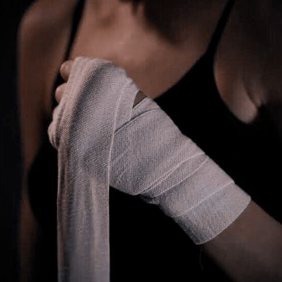 a woman with bandages on her arm and hand