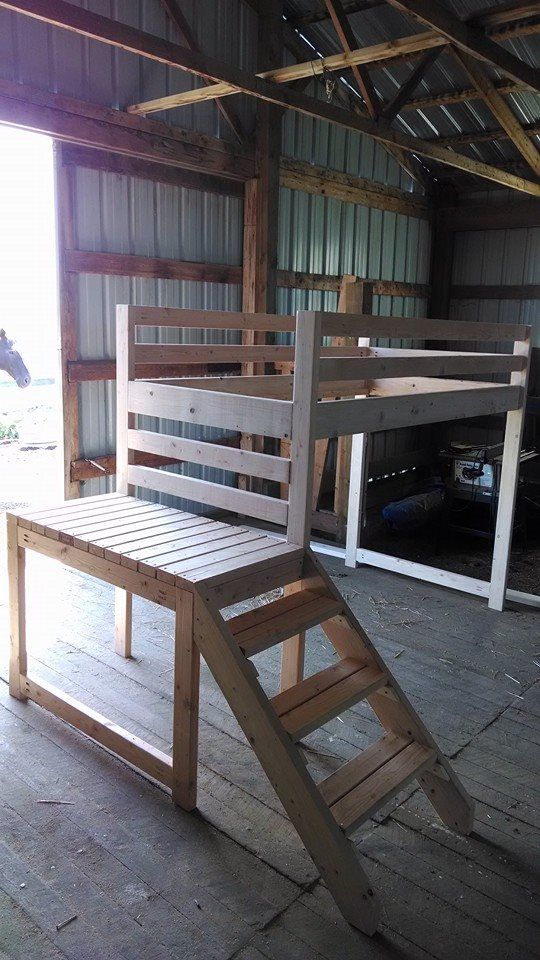 a wooden bench made out of pallets in a garage