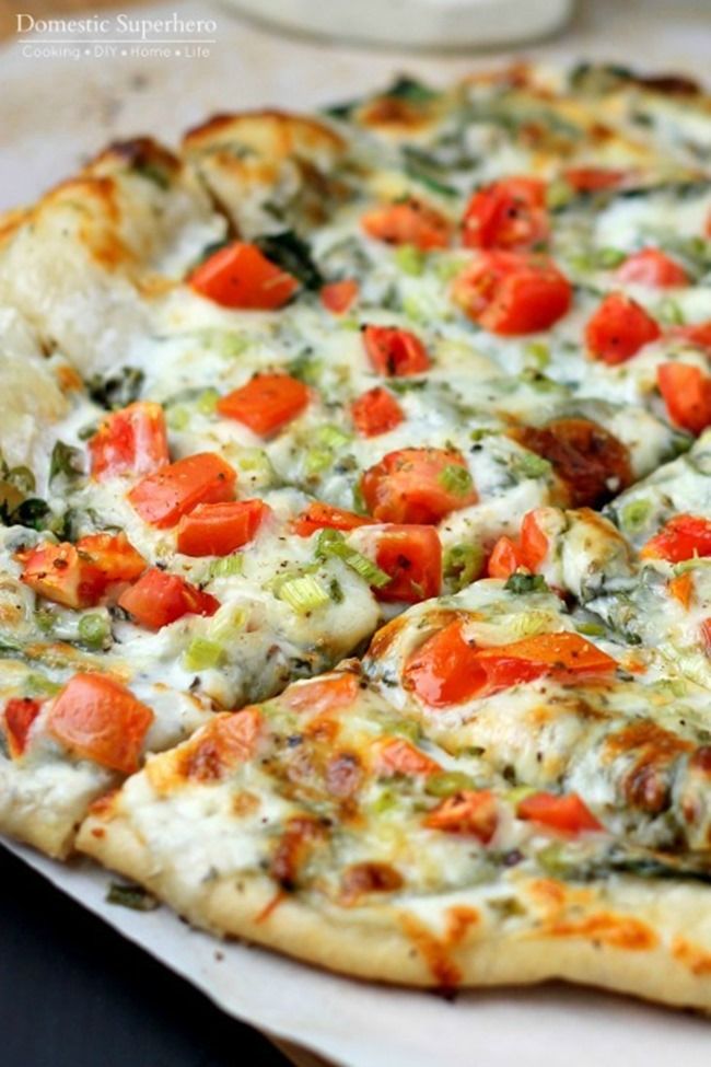 a pizza sitting on top of a pan covered in cheese and veggie toppings