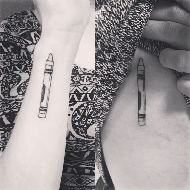 two people with matching tattoos on their arms holding up pencils and writing utensils