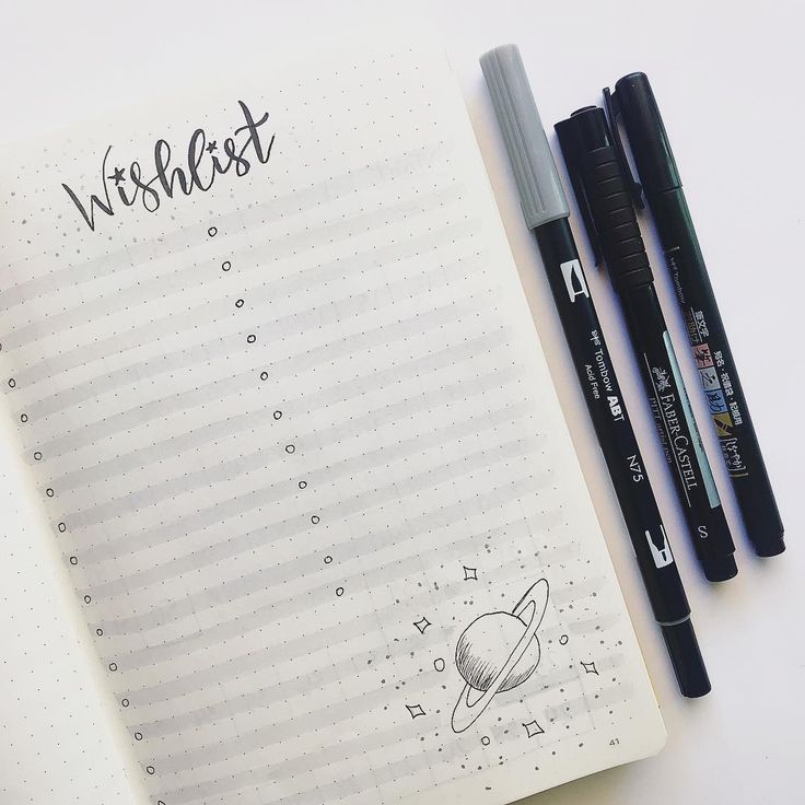 two pens are sitting on top of a notebook with the words wishest written in it