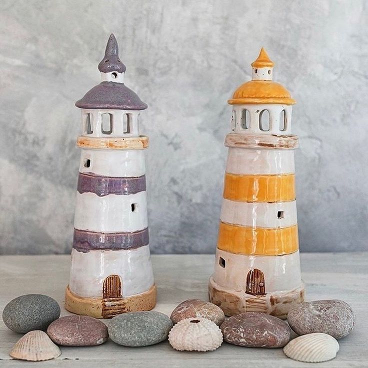 two ceramic lighthouses sitting next to each other