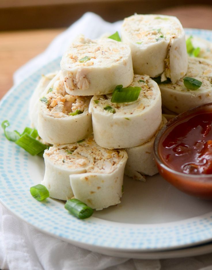 some food is sitting on a plate with ketchup and sauce in the middle