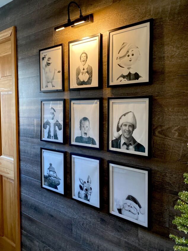 a wall with many framed pictures on it