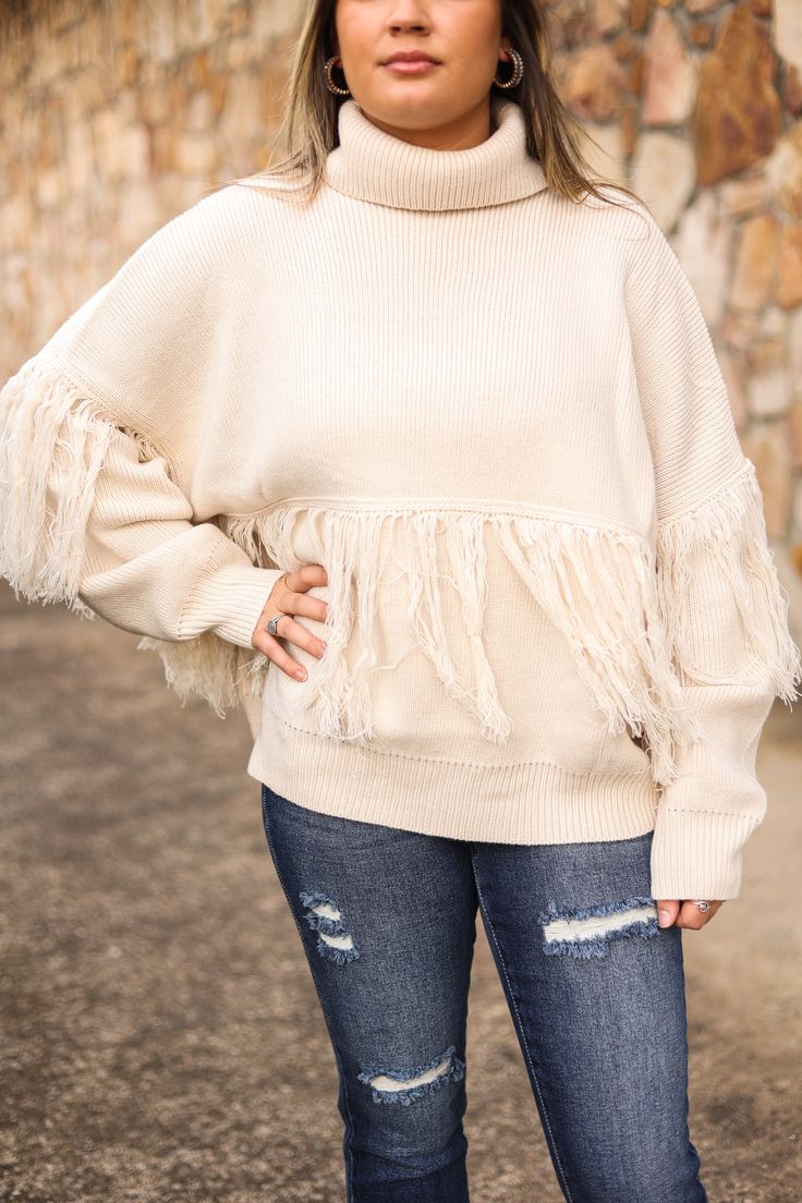 Our "Fringe Turtle Neck Sweater" is a cream colored sweater with a fringe detail and turtle neckline. Our model is wearing a size Small. Chic Fringe Tops For Fall, Fall Beige Fringe Top, Chic Fringe Sweater For Fall, Beige Long Sleeve Sweater With Fringe, Beige Fringe Casual Sweater, Cream Colored Sweater, Turtle Neck Sweater, Turtleneck Sweater, Kids Accessories