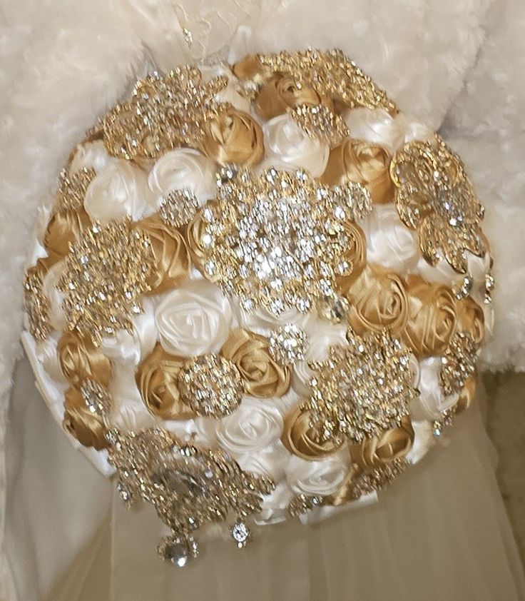 a bridal bouquet with gold and white flowers