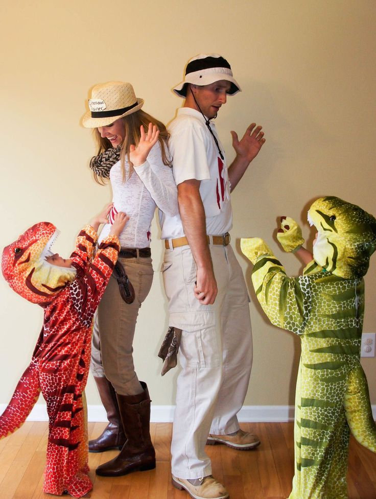 three people in costumes standing next to each other on a hard wood flooring area