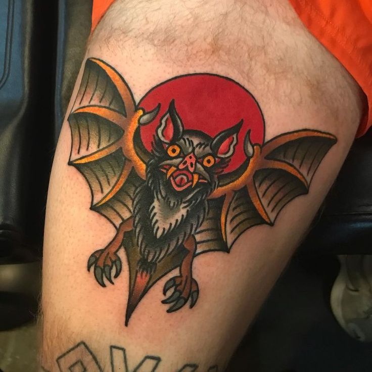 a man with a bat tattoo on his leg