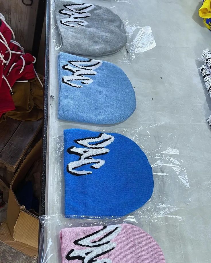 three pairs of shoes sitting on top of a table