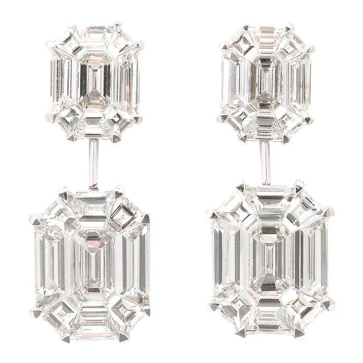 These earrings give the illusion of 5-6 carat EACH emerald cut drops! 5.02 carats of F VS special cut diamonds, masterly set to look like one emerald cut diamond. Set in 18k white gold .90 inch length. A wearable pair of earrings, full of sparkle! Luxury Emerald Cut Classic Diamond Earrings, Luxury Classic Emerald Cut Diamond Earrings, Luxury Square-cut Diamond Accent Earrings, Luxury Diamond-shaped Diamond Cut Earrings, Emerald Cut Dismond Earring, Luxury Silver Emerald Cut Earrings, Luxury Emerald Cut Fine Jewelry Earrings, Luxury Silver Emerald Cut Jewelry, Luxury Square-cut Diamond Earrings