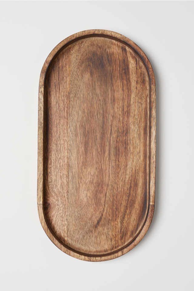 an oval wooden tray on a white background