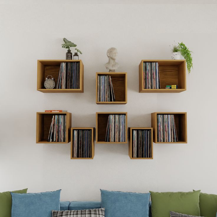 there are many bookshelves on the wall above the couch and in the corner