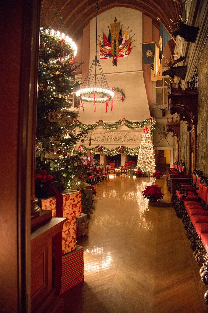 a large hall decorated with christmas trees and presents