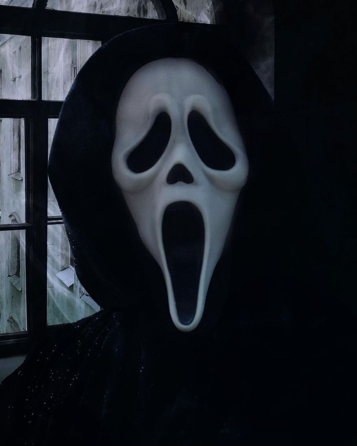 a person wearing a ghost mask with their mouth open