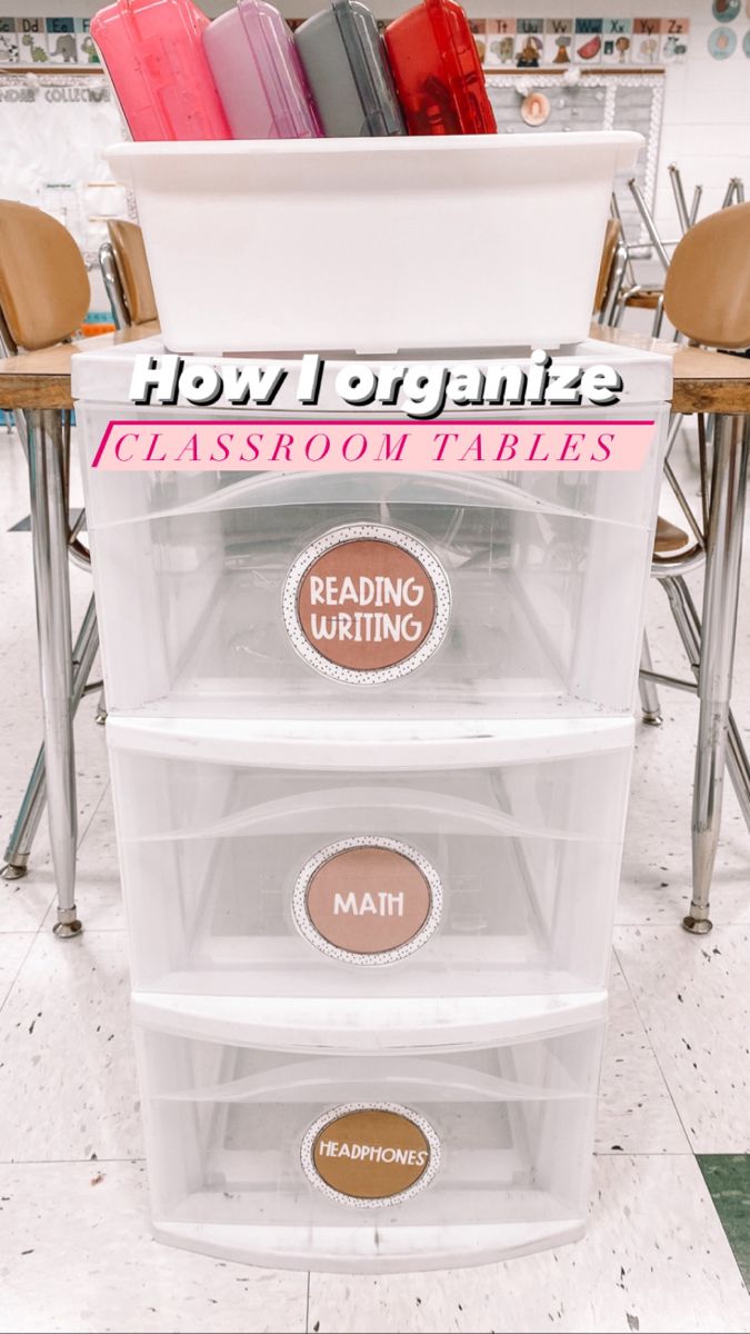 three plastic containers with labels on them sitting in front of some chairs and desks