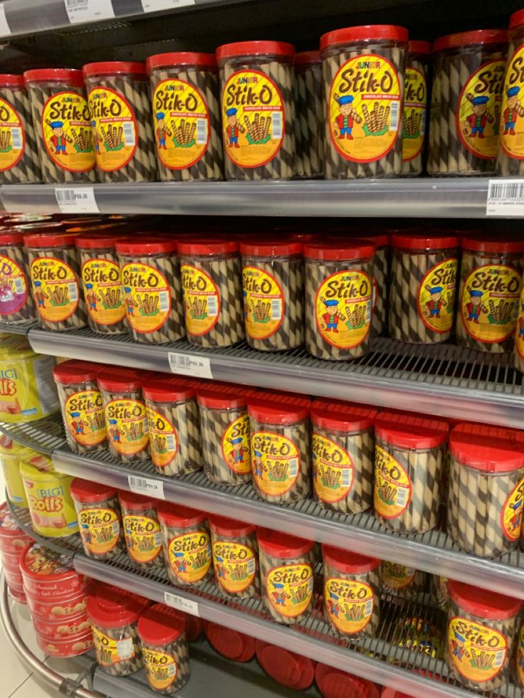 the shelves are filled with different types of food in plastic containers and on top of each other