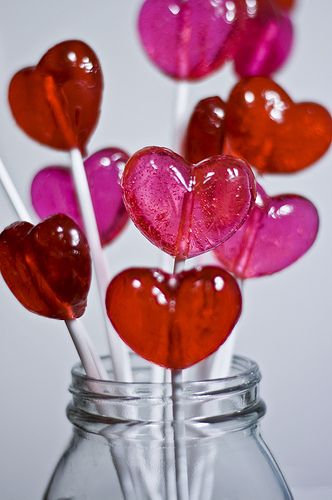 several heart shaped lollipops in a jar