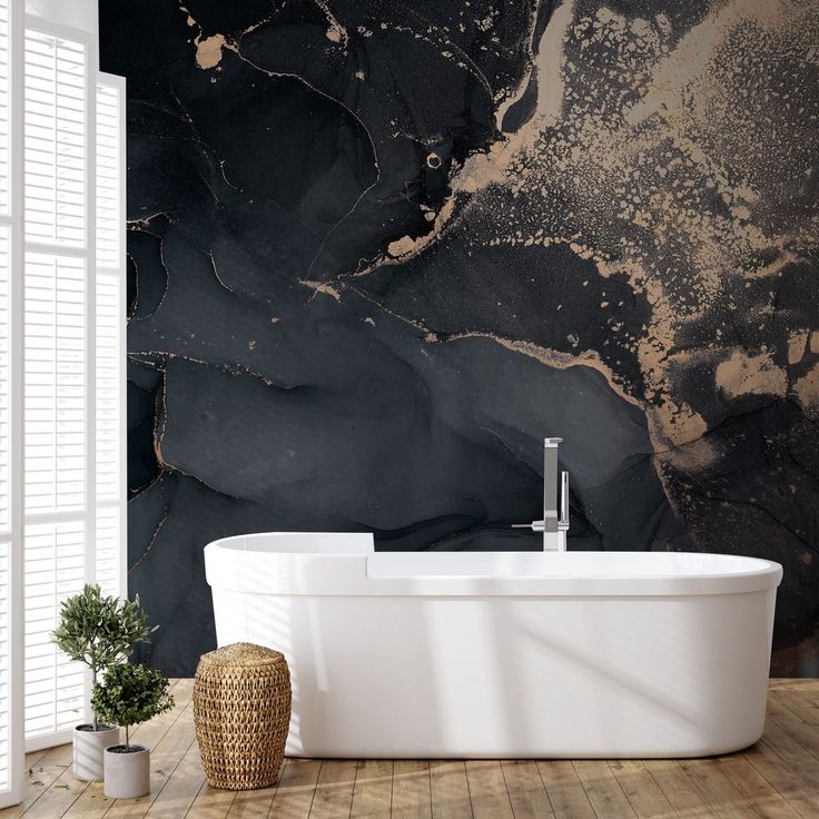 a bathtub sitting on top of a wooden floor next to a wall covered in black marble