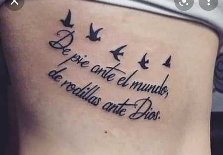 a woman's back with birds flying around her and the words written on it