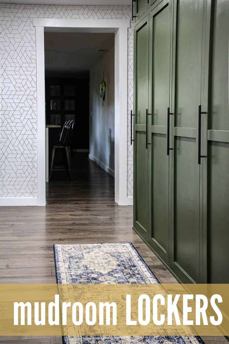 a hallway with green cabinets and a blue rug on the floor in front of it