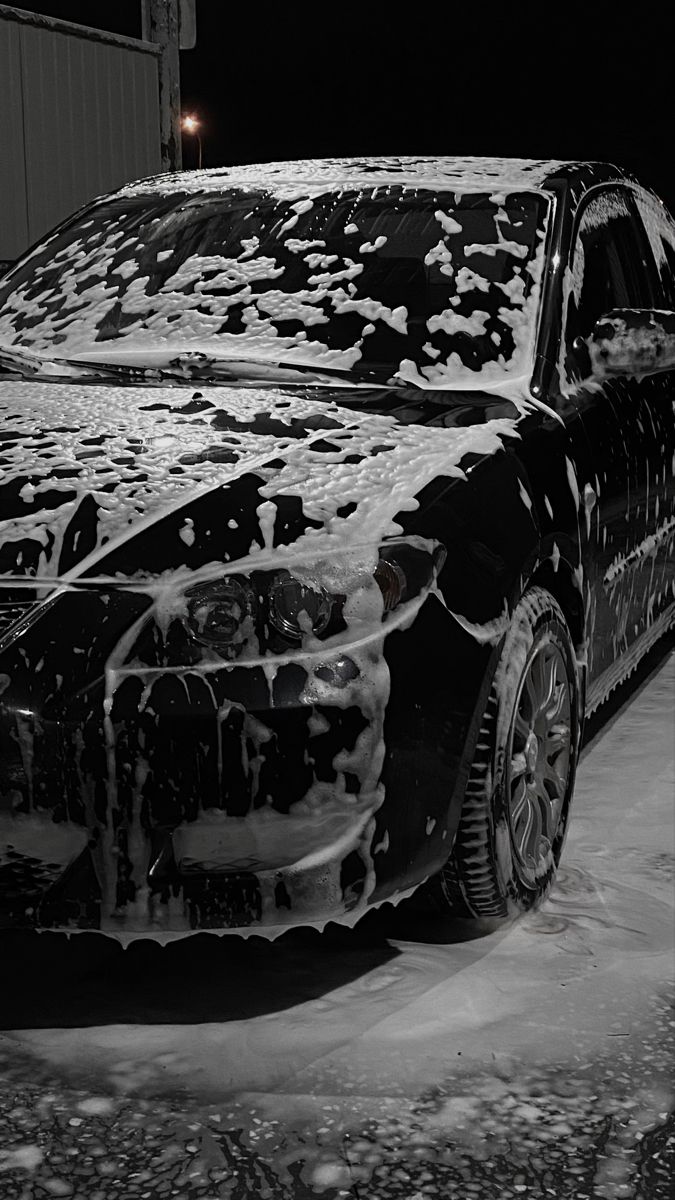 a black car covered in ice and snow