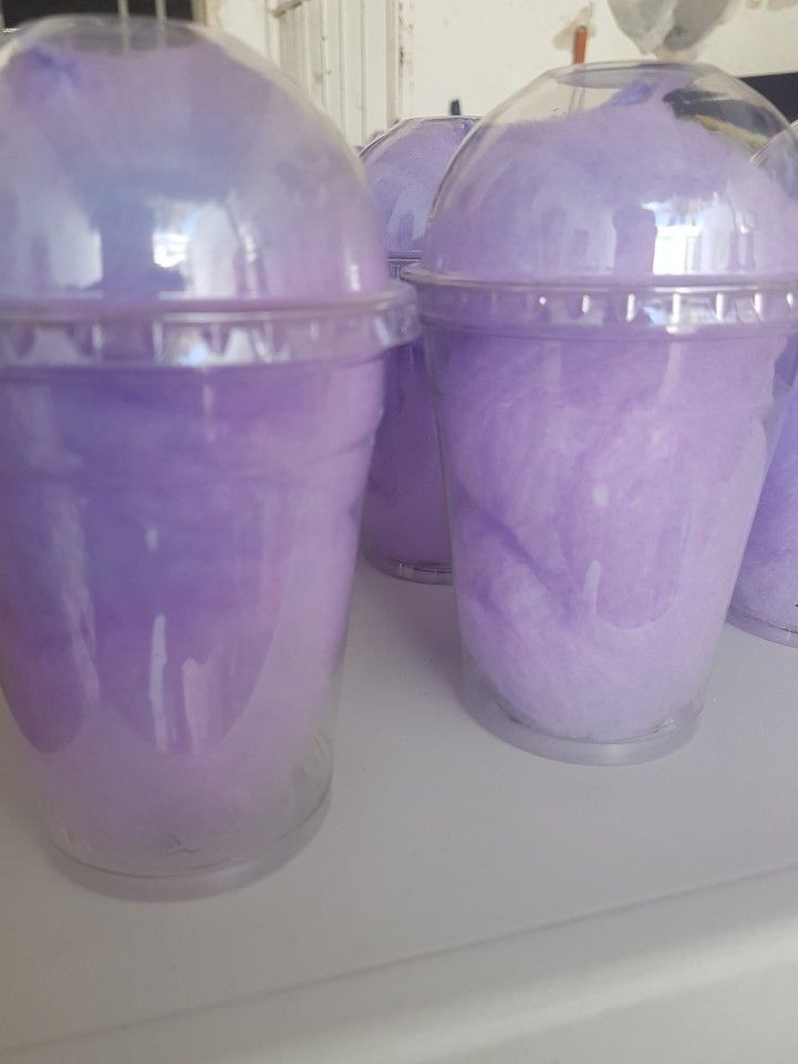 three plastic containers filled with purple stuff on top of a counter