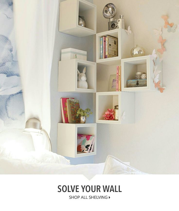 a bedroom with white walls and shelving on the wall is featured in this ad