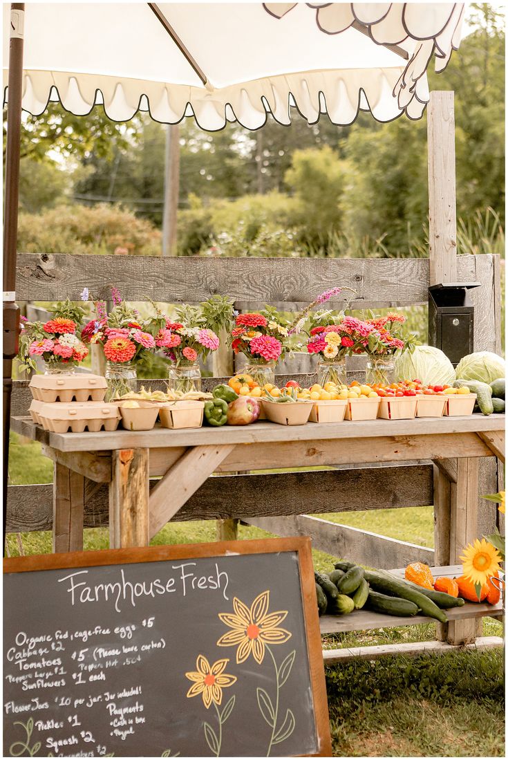 an outdoor farmers market with flowers and vegetables