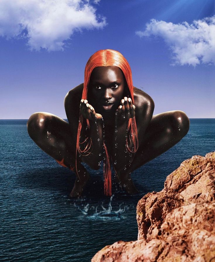 a woman with red hair is sitting in the water